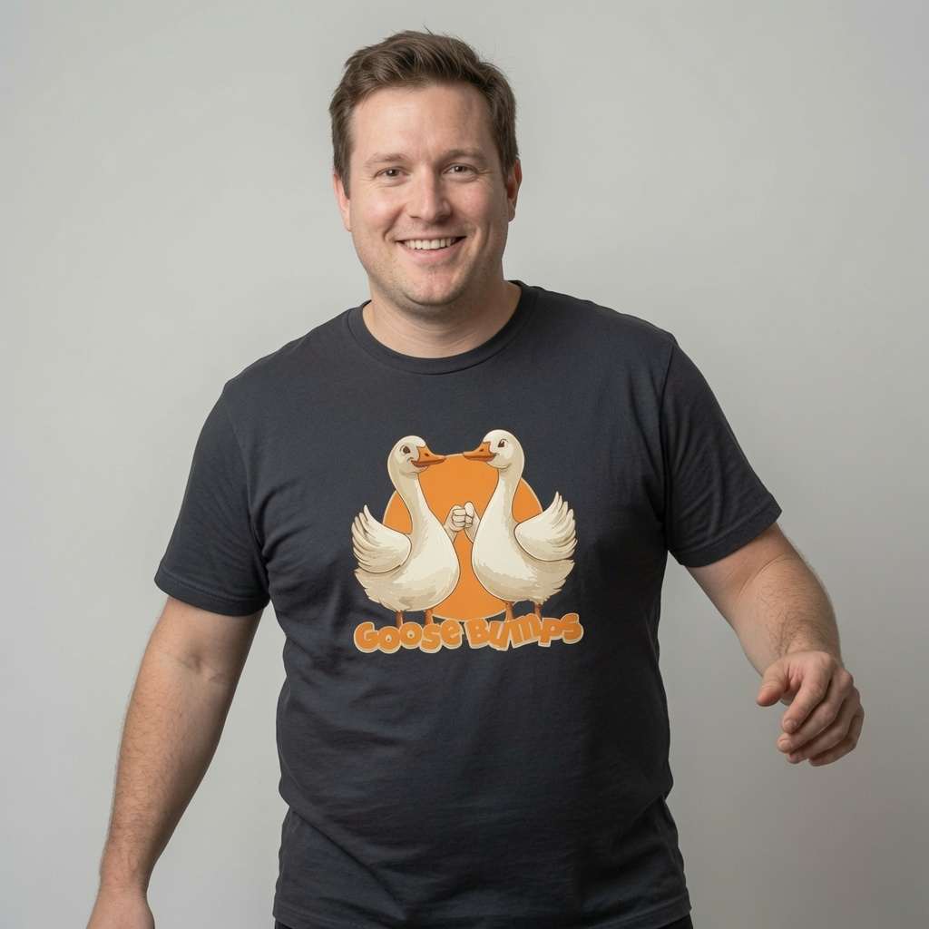 Man smiling in black Goose Bumps tee with fist-bumping geese, funny mens goose pun
