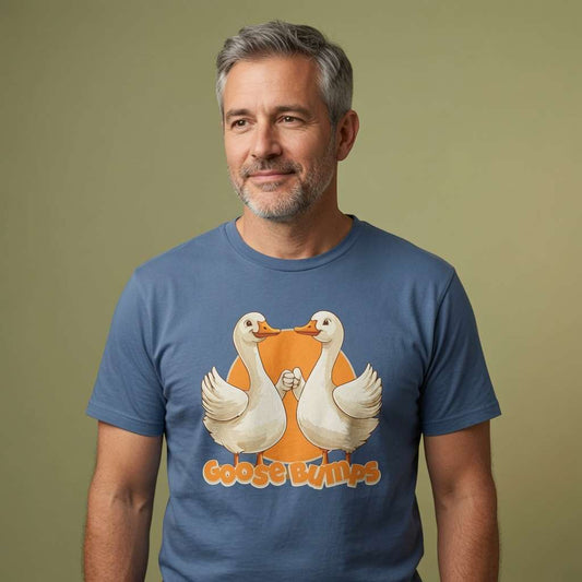 Grey-haired bearded man with slight smile in bright blue Goose Bumps t-shirt, funny witty mens goose pun graphic