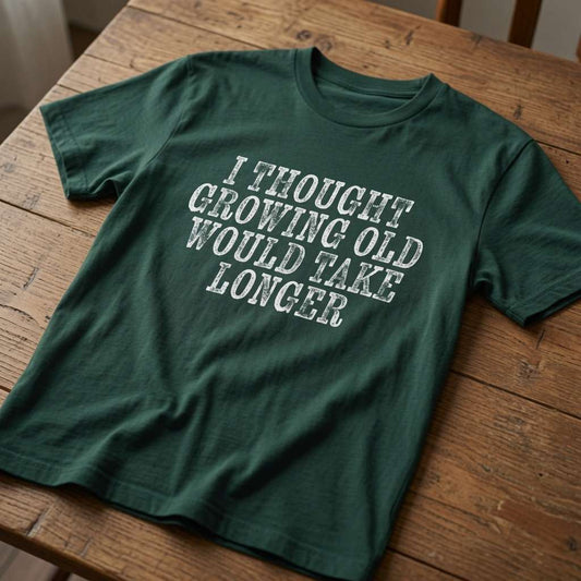Glazed green I Thought Growing Old Would Take Longer t-shirt on wood, humorous mens relatable age slogan