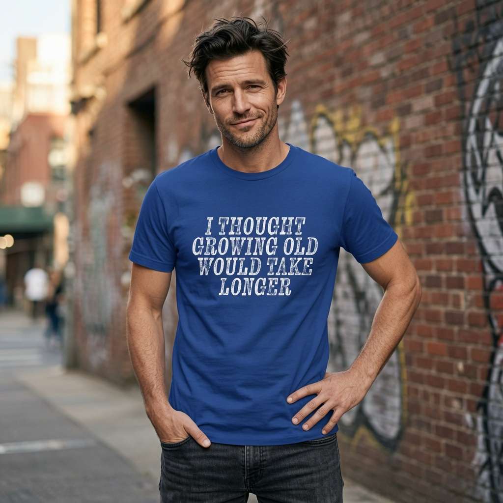Man with hand on hip in worker blue I Thought Growing Old Would Take Longer t-shirt, fun witty mens age related slogan
