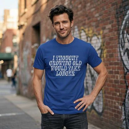Man with hand on hip in worker blue I Thought Growing Old Would Take Longer t-shirt, fun witty mens age related slogan