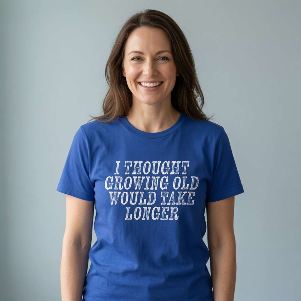 Woman smiling in worker blue I Thought Growing Old Would Take Longer t-shirt, ladies age related slogan