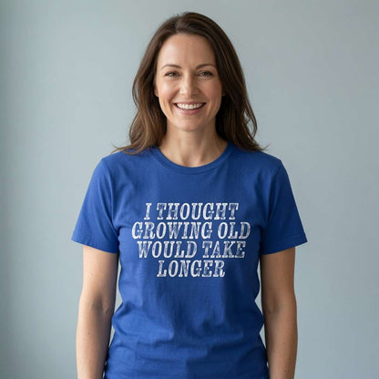 Woman smiling in worker blue I Thought Growing Old Would Take Longer t-shirt, ladies age related slogan