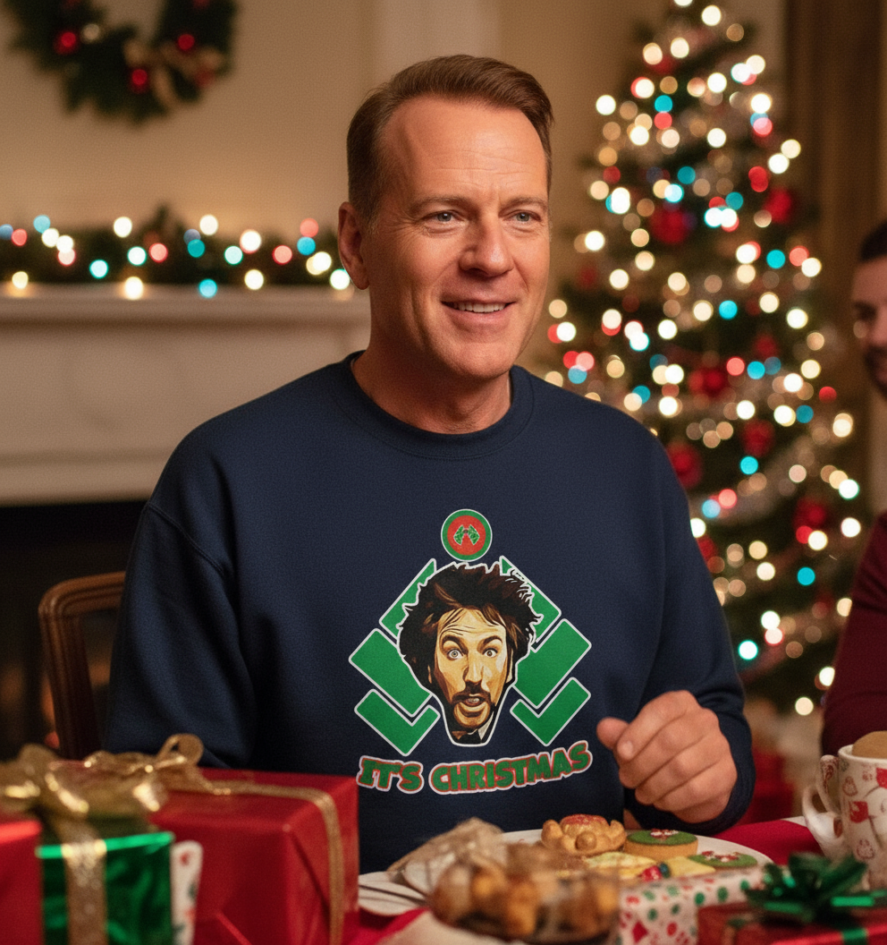 Man wearing a Christmas-themed sweatshirt with a festive background
