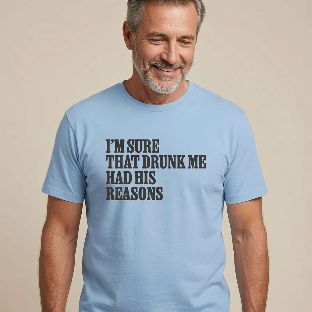 Grey-haired bearded man smiling looking down in light blue I’m Sure That Drunk Me Had His Reasons t-shirt, funny cheeky pub banter