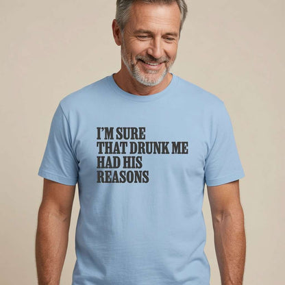 Grey-haired bearded man smiling looking down in light blue I’m Sure That Drunk Me Had His Reasons t-shirt, funny cheeky pub banter