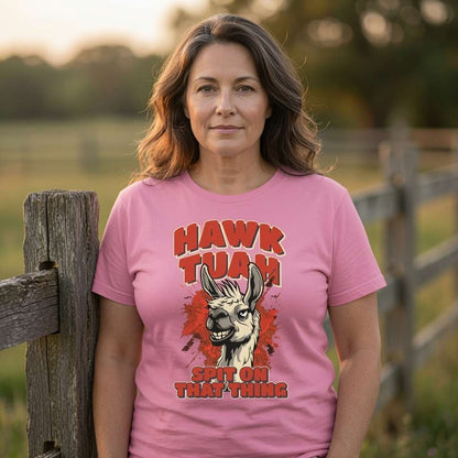 Woman by fence in pink Hawk Tuah Spit on That Thing tee, ladies funny meme graphic