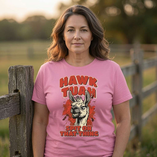 Woman by fence in pink Hawk Tuah Spit on That Thing tee, ladies funny meme graphic