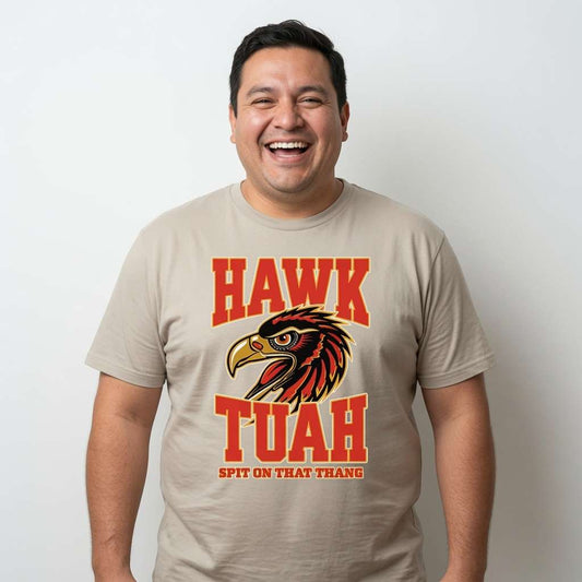 Man laughing in beige Hawk Tuah Spit on That Thang tee with hawk design, funny witty mens meme graphic