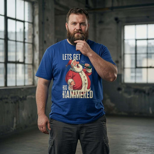Bearded man in warehouse in blue Let’s Get Ho Ho Hammered t-shirt, funny mens xmas beer banter graphic