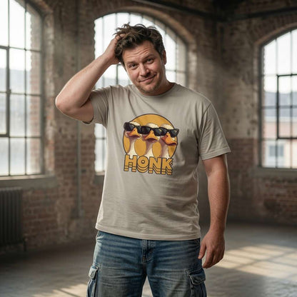 Man with hand on head in beige HONK tee with cool geese design, funny mens cheeky goose honk graphic