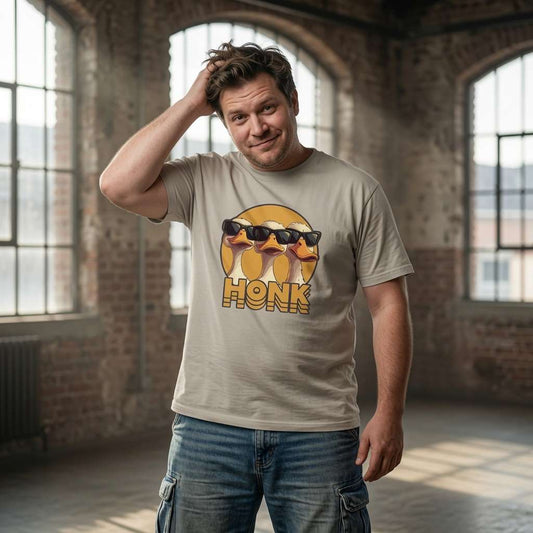 Man with hand on head in beige HONK tee with cool geese design, funny mens cheeky goose honk graphic