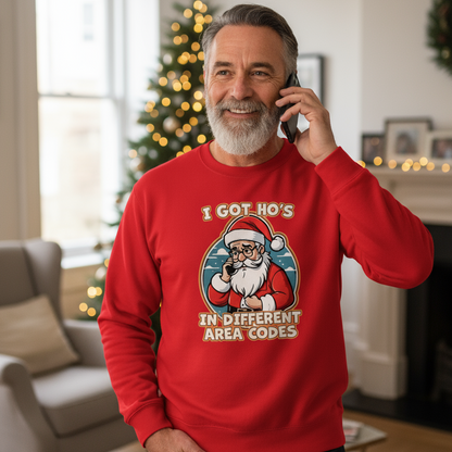 Man wearing a red Christmas sweater with Santa Claus graphic and text, standing in a living room decorated for Christmas.