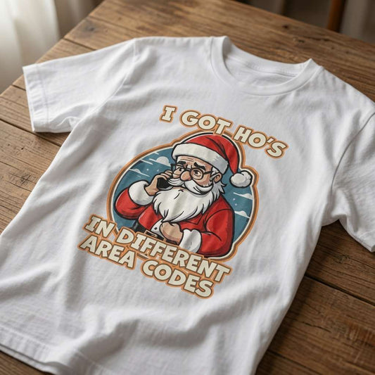 White I Got Ho’s in Different Area Codes t-shirt on wood featuring Santa on the phone, funny mens witty xmas pun graphic