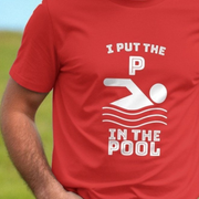 Red dad joke t-shirt with white graphic and slogan 'I PUT THE P IN THE POOL' on a blurred background