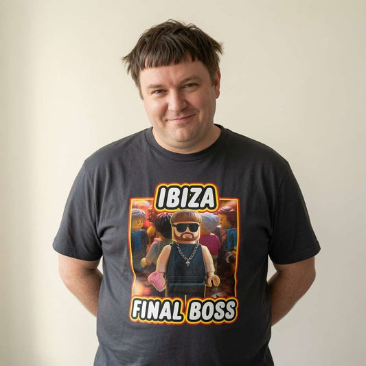 Man with slight smile in black Ibiza Final Boss tee with Lego Ibiza graphic, fun witty mens viral meme graphic