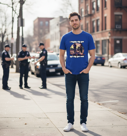 Man wearing a blue t-shirt with a graphic design on a city street.