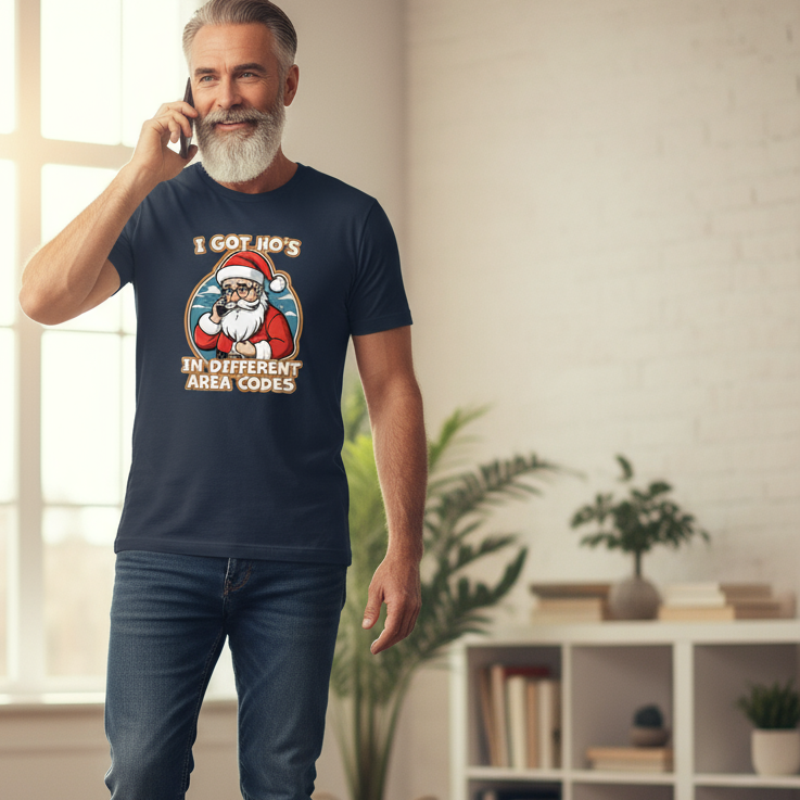 Man wearing a navy blue t-shirt with a Santa Claus graphic and text, standing in a room with plants and a shelf.