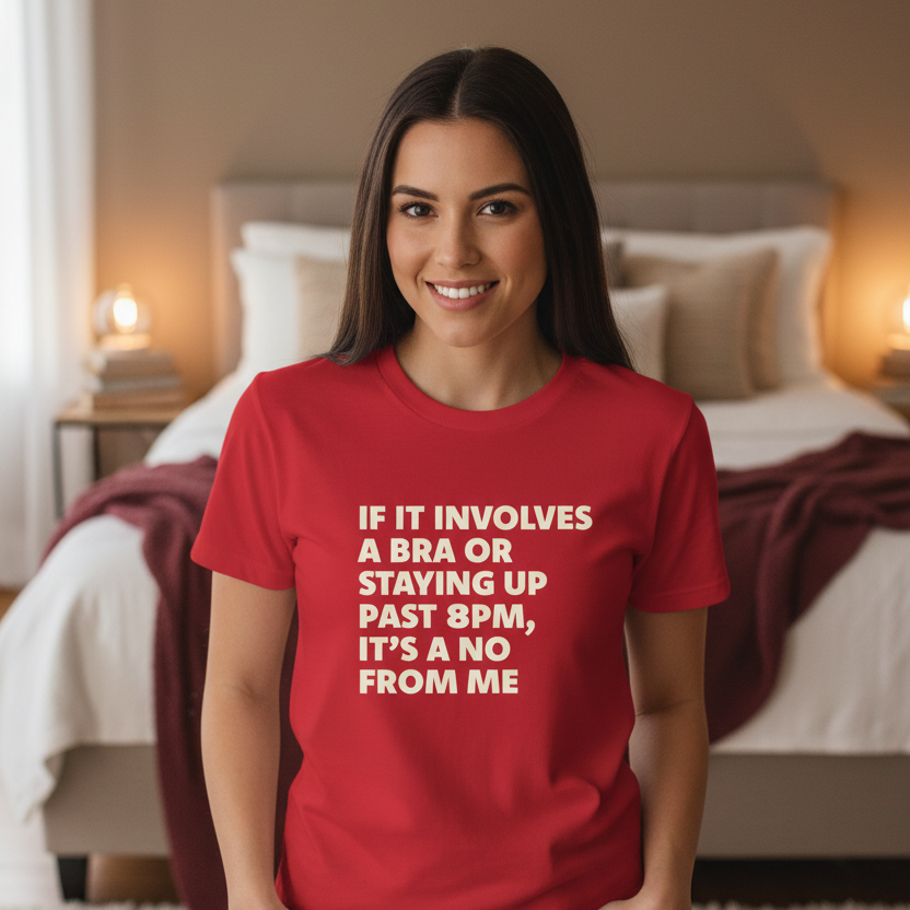Woman wearing a red t-shirt with a humorous message in a bedroom setting