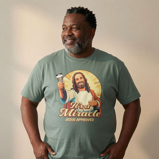 Man smiling looking to the side in green It’s a Miracle Jesus Approved t-shirt, mens funny offensive jesus graphic