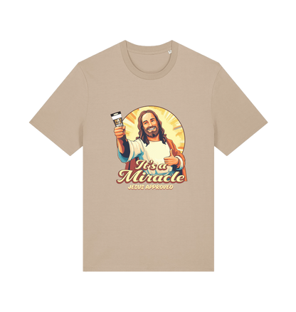 beige funny jesus t-shirt with the graphic of jesus holding a tube of no more nails and the slogan 'it's a miracle jesus approved'