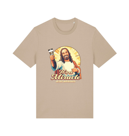 beige funny jesus t-shirt with the graphic of jesus holding a tube of no more nails and the slogan 'it's a miracle jesus approved'