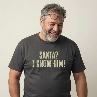 Man laughing with glasses on head in black Santa? I Know Him! tee, cheeky memorable santa slogan