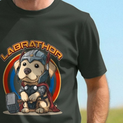 Black labrador t-shirt with a cute cartoon dog dressed like thor, wearing armor and holding a hammer, labeled 'Labrathor', on a blue and green gradient background.