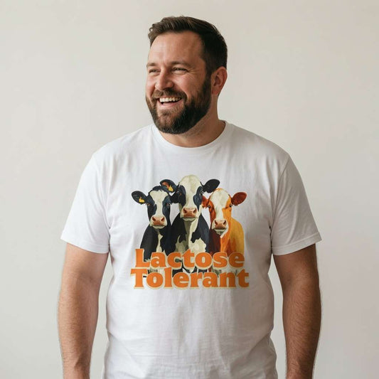 Bearded man smiling looking to the side in white Lactose Tolerant t-shirt, witty mens fun animal graphic