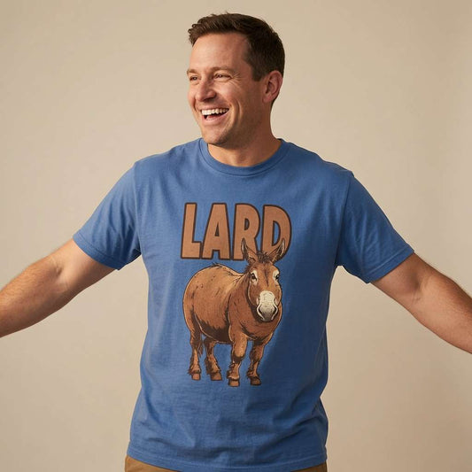 Man with slight smile looking to the side in navy Lactose Tolerant tee with cows design, mens cheeky fun cow graphic