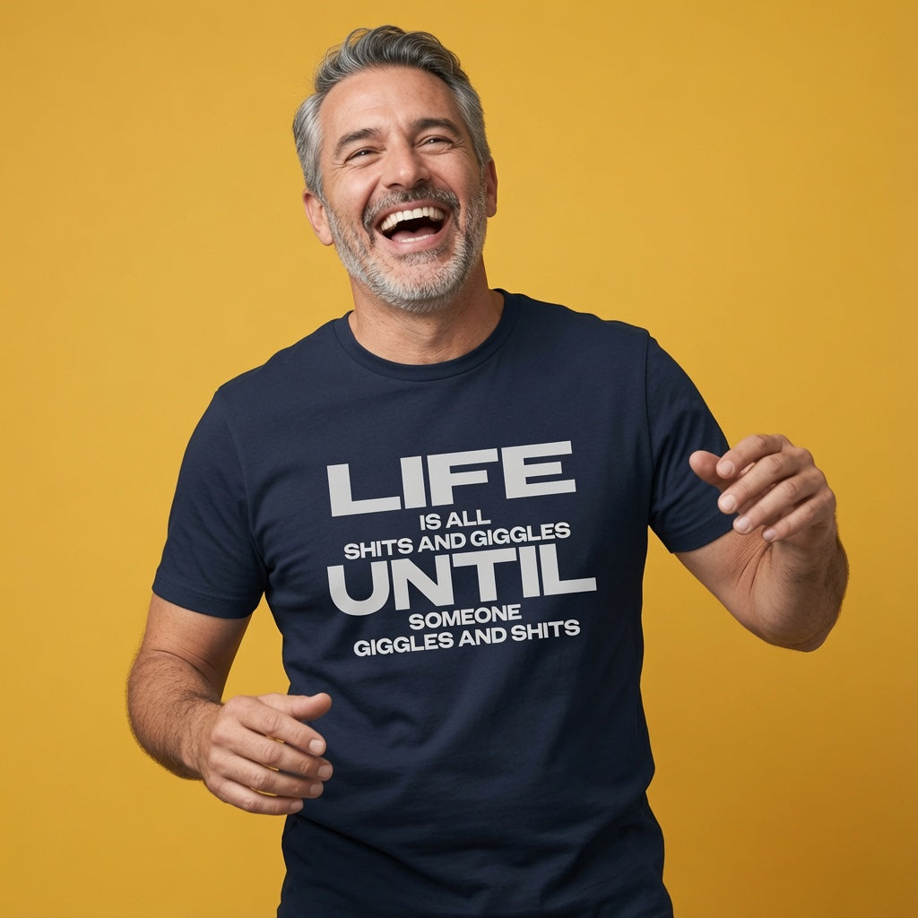 Man laughing while wearing a navy Life Is All Shits And Giggles Until Someone Giggles And Shits t-shirt, funny mens relatable age related slogan design that every cheeky lad will claim