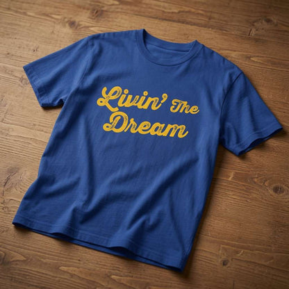 Blue Livin’ The Dream t-shirt on wood, mens witty relatable sarcastic slogan