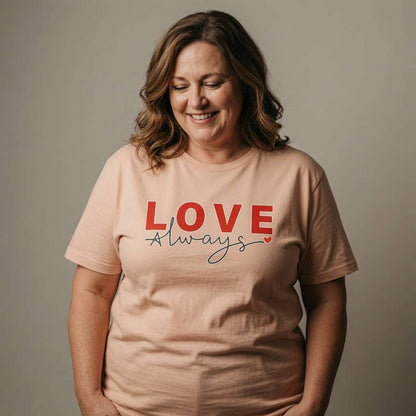 Woman smiling looking down in peach Love Always tee, ladies kindness tee for mum