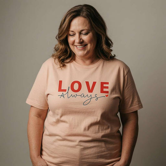 Woman smiling looking down in peach Love Always tee, ladies kindness tee for mum