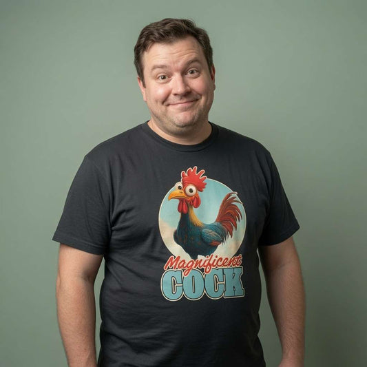 Man with slight smile looking to the side in black Magnificent Cock tee with rooster design, funny mens cockerel pun graphic