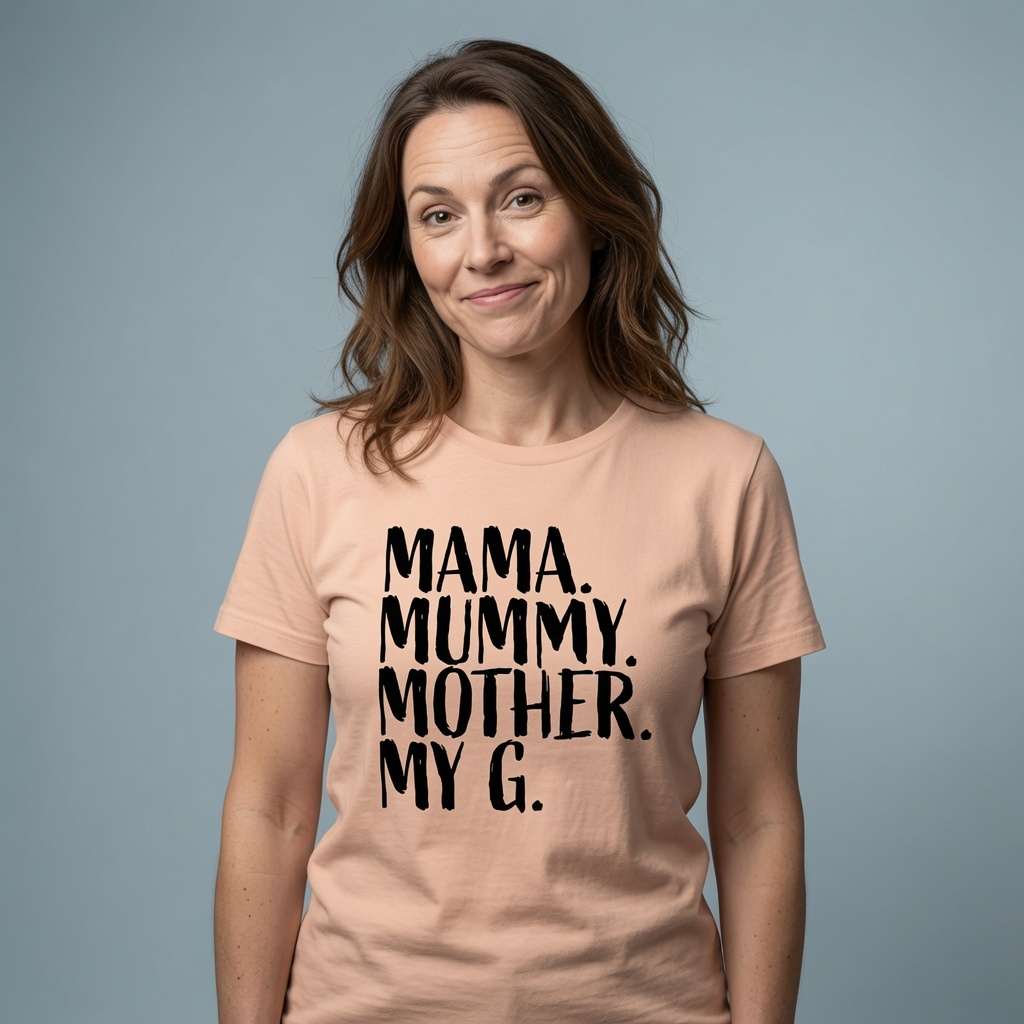 Woman with slight smile raised eyebrows in peach Mama Mummy Mother My G t-shirt, fun relatable mothers day gift