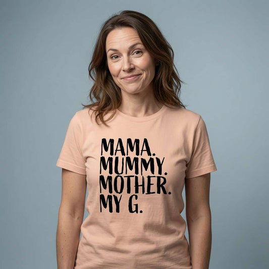 Woman with slight smile raised eyebrows in peach Mama Mummy Mother My G t-shirt, fun relatable mothers day gift