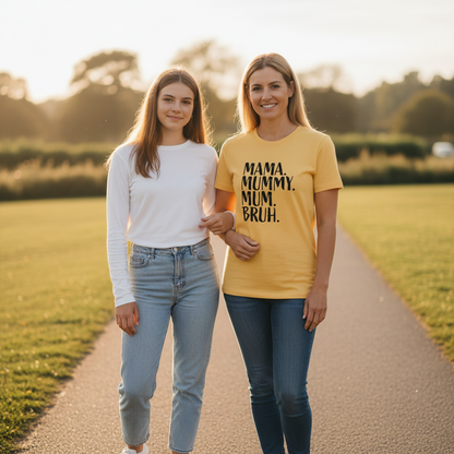 Two women standing on a path in a park, one wearing a yellow t-shirt with text.