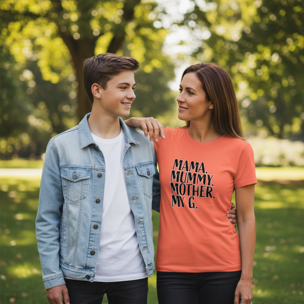 Woman wearing an orange t-shirt with text standing outdoors with a young boy.