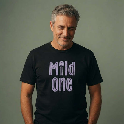 Grey-haired man smiling looking down in black Mild One t-shirt, cheeky fun matching slogan