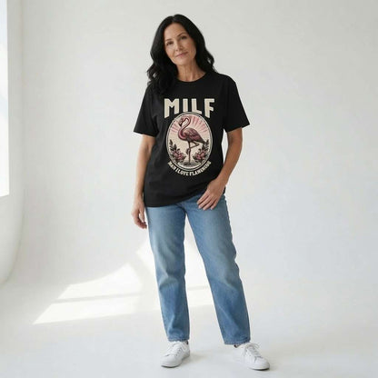 Woman standing with hand in pocket in black MILF Man I Love Flamingos t-shirt, fun witty ladies rude flamingo graphic