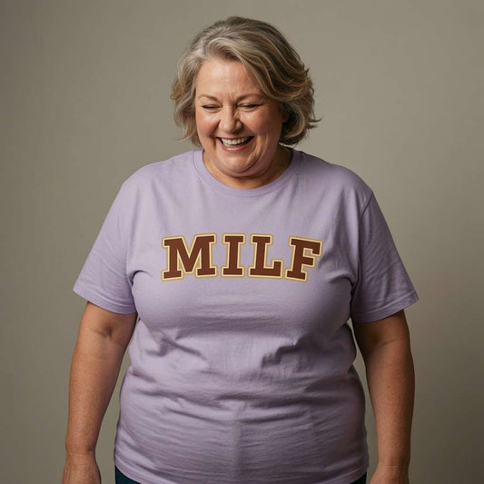 Older woman laughing in lavender MILF tee, witty cheeky mum slogan gift