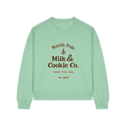green xmas sweater with the slogan 'north pole milk and cookie co'