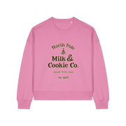 pink xmas sweater with the slogan 'north pole milk and cookie co'