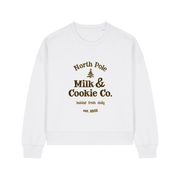 white xmas sweater with the slogan 'north pole milk and cookie co'