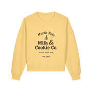 yellow xmas sweater with the slogan 'north pole milk and cookie co'