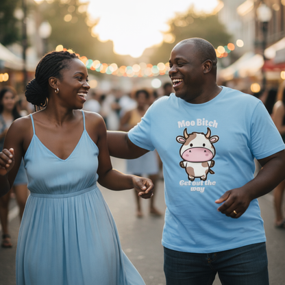 Man and woman walking together at a festival, man wearing a blue t-shirt with a cow graphic.