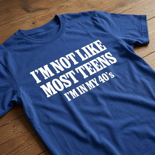 Blue I’m Not Like Most Teens I’m In My 40’s t-shirt on wood, mens funny cheeky 40s age related slogan