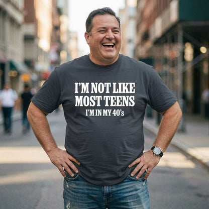 Man laughing with hands on hips in ink grey I’m Not Like Most Teens I’m In My 40’s tee, mens funny witty 40 age related slogan