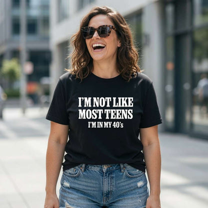 Woman laughing with sunglasses in black I’m Not Like Most Teens I’m In My 40’s tee, fun ladies relatable slogan